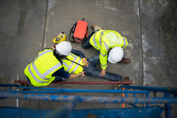 construction worker attending to injured worker